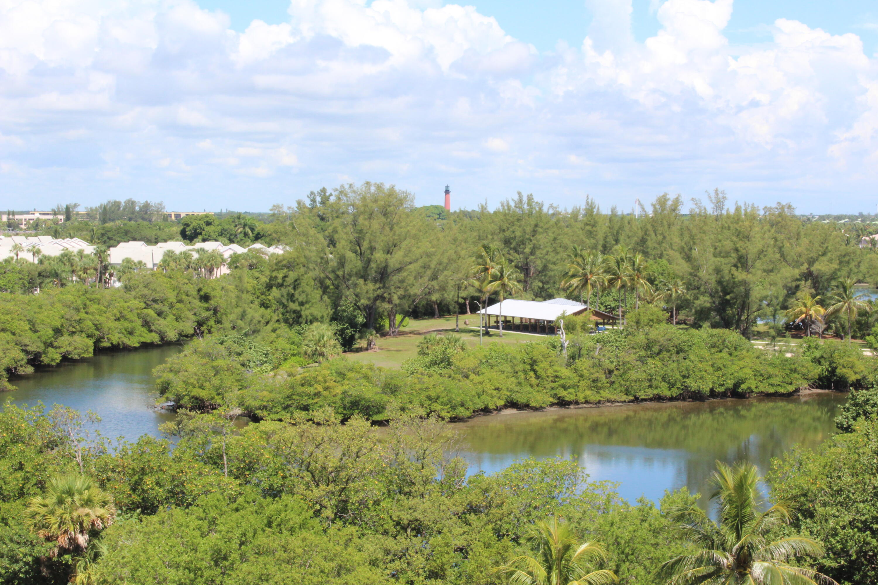 400 Ocean Trail Way, Unit 504 Jupiter, FL 33477 - Photo 26 of 27 a swimming pool with lawn chairs and wooden fence