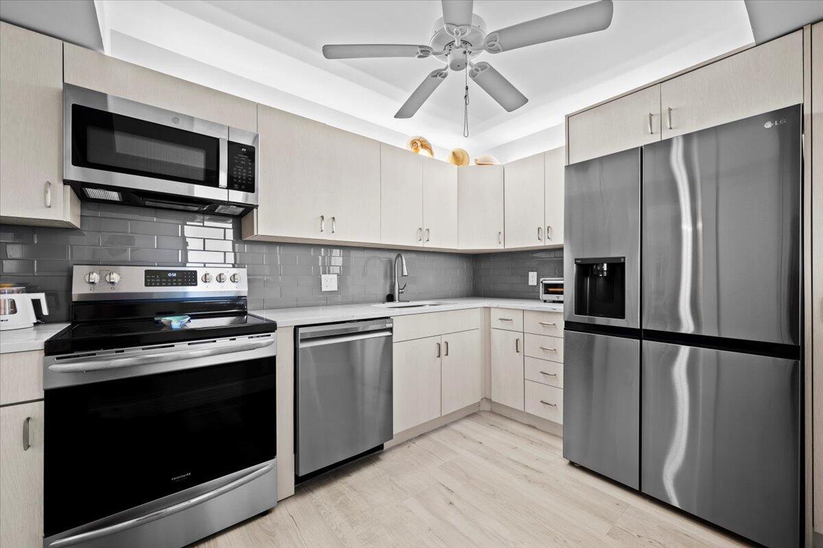 400 Ocean Trail Way, Unit 504 Jupiter, FL 33477 - Photo 7 of 27 a kitchen with a stove microwave and refrigerator