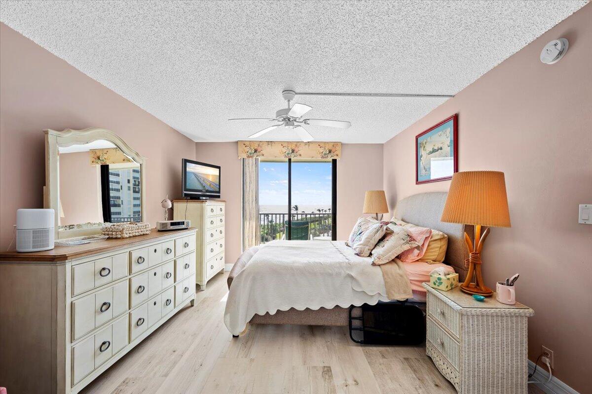 400 Ocean Trail Way, Unit 504 Jupiter, FL 33477 - Photo 9 of 27 a bedroom with bed and window with lamp