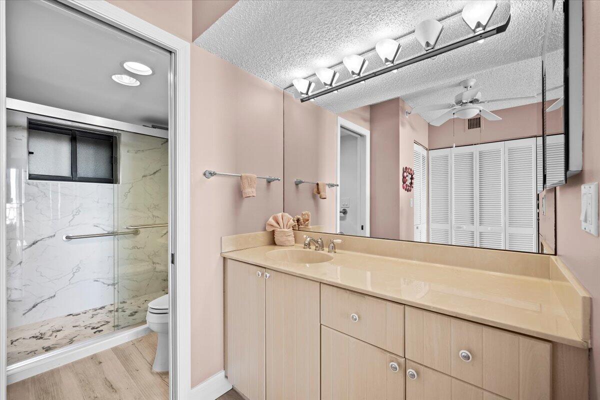 400 Ocean Trail Way, Unit 504 Jupiter, FL 33477 - Photo 10 of 27 a bathroom with a sink and a mirror