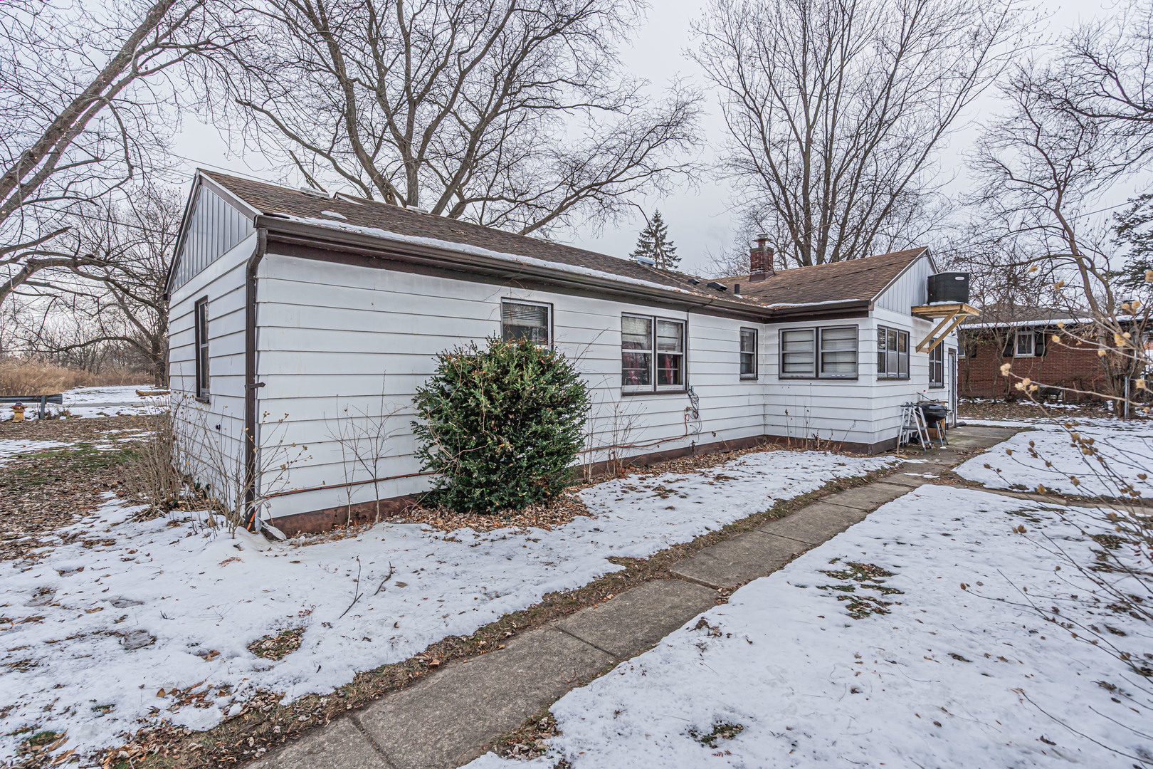 1760 East 158th Street Dolton, IL 60419 - Photo 17 of 22 a view of a house with a snow on the road