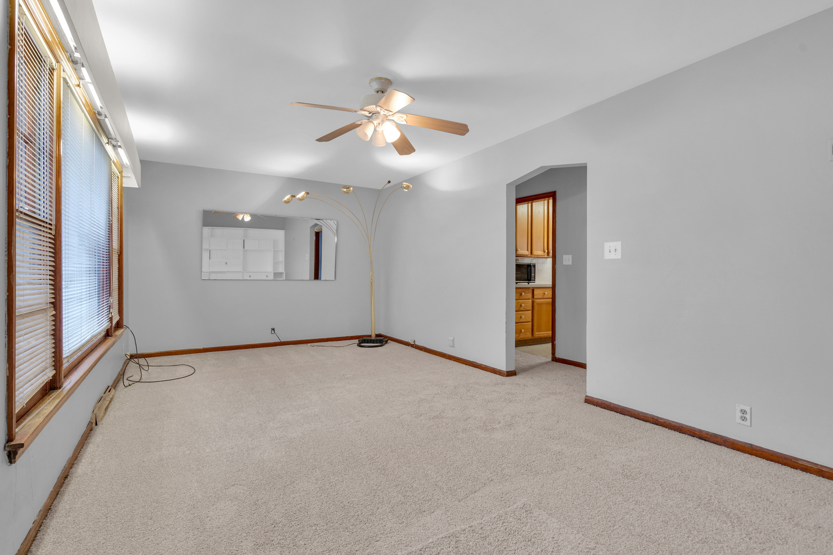 1760 East 158th Street Dolton, IL 60419 - Photo 3 of 22 an empty room with chandelier fan and windows