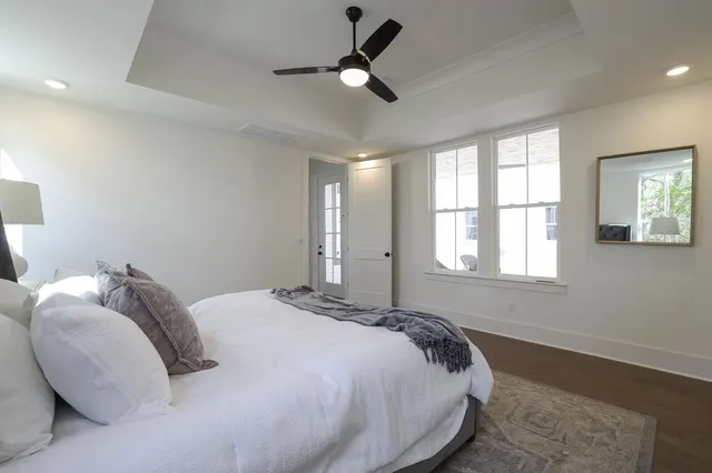 a bed sitting in a bedroom next to a window