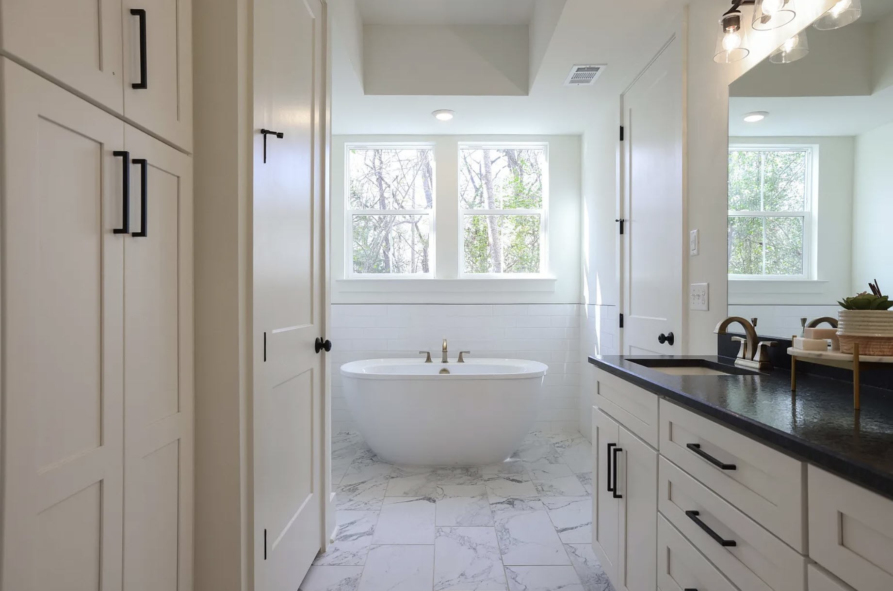 207 Fairground Street, Unit 103 Franklin, TN 37064 - Photo 14 of 27 a bathroom with a tub sink toilet and mirror