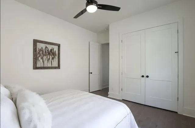 a bedroom with a bed and a painting on the wall