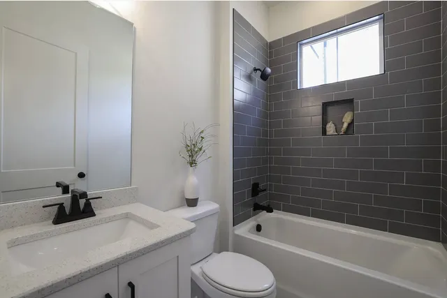 a bathroom with a sink a toilet and bathtub