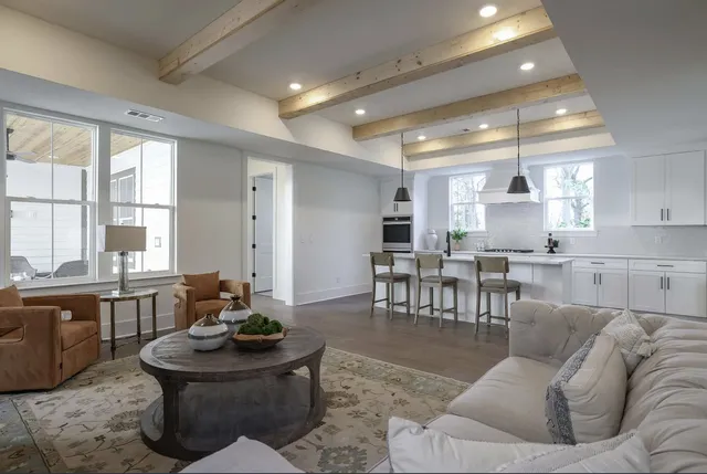 a living room with furniture and kitchen view