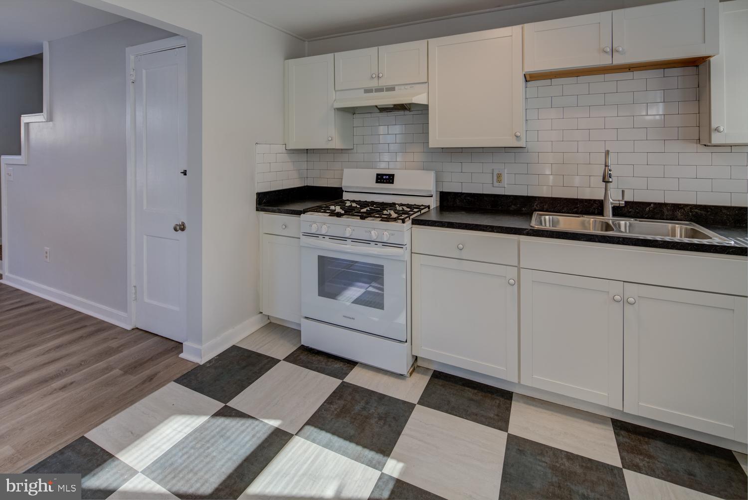 36 Thompson Circle Newark, DE 19711 - Photo 18 of 22 a kitchen with granite countertop white cabinets and appliances