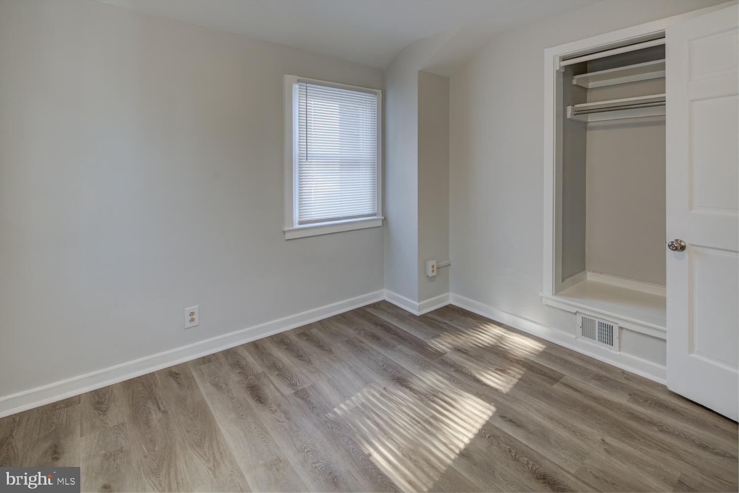 36 Thompson Circle Newark, DE 19711 - Photo 7 of 22 an empty room with wooden floor and windows