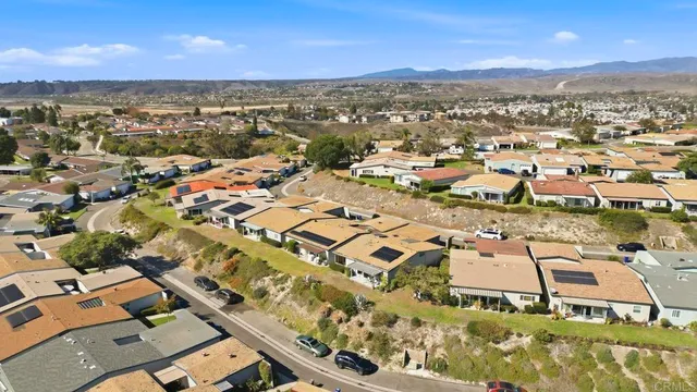 an aerial view of residential building with parking