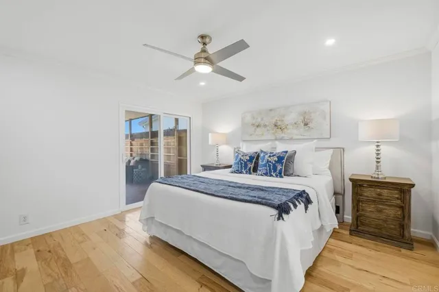 a bed room with a bed and a ceiling fan