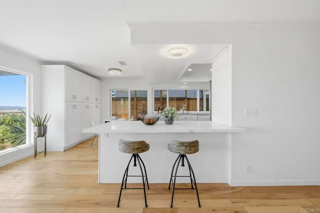 a kitchen with stainless steel appliances kitchen island a chandelier