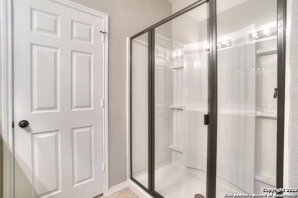 a bathroom with a glass shower door