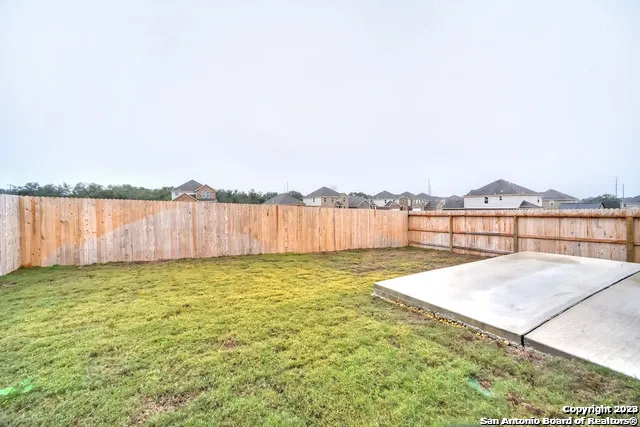 a view of swimming pool with lake and houses in the back