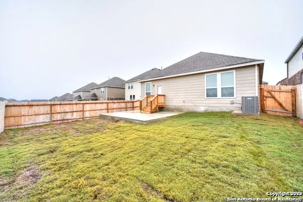a view of a house with a backyard and a patio