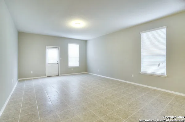 an empty room with windows and closet