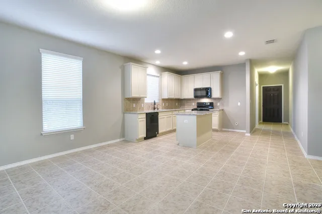 a kitchen with stainless steel appliances granite countertop a refrigerator sink and cabinets