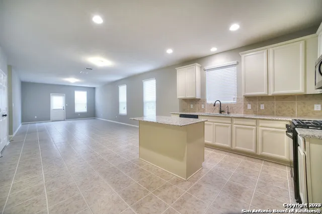 a view of a kitchen with a sink and cabinets
