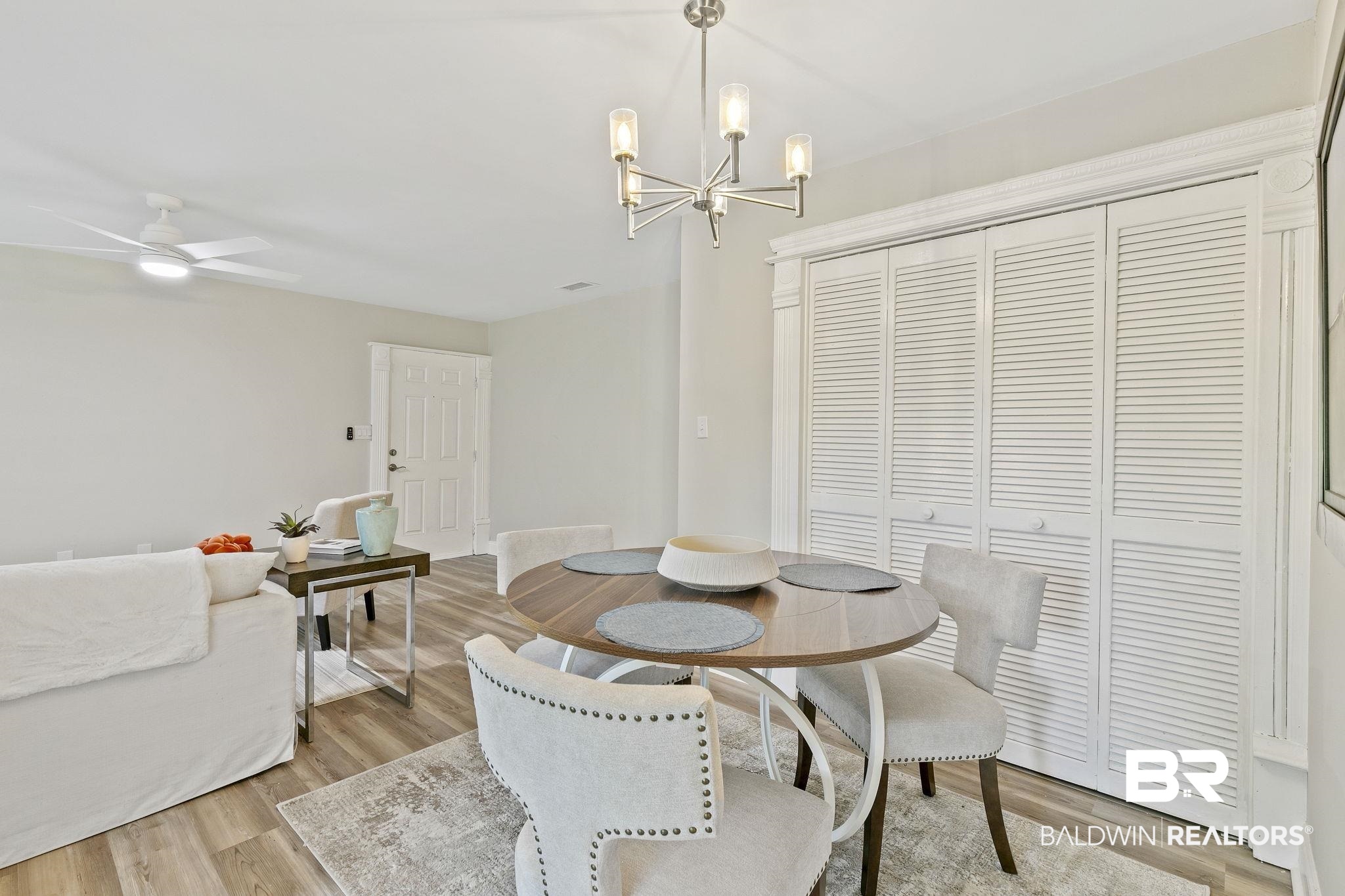 110 5th Street, Unit C103 Daphne, AL 36526 - Photo 13 of 46 Dining area with ceiling fan with notable chandelier and light wood-type flooring