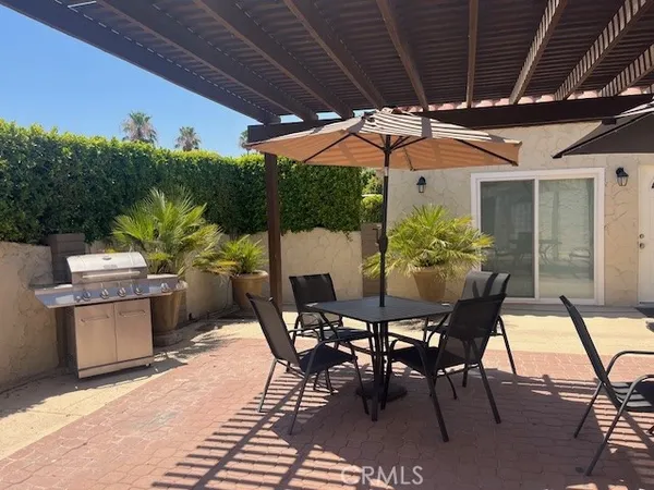 a patio with a table and chairs