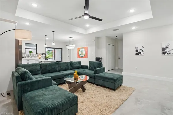 a living room with furniture and a chandelier