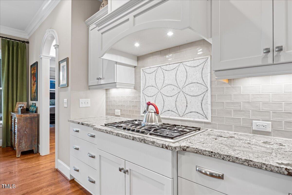 3034 Lewis Farm Road Raleigh, NC 27607 - Photo 16 of 60 a kitchen with granite countertop cabinets and a stove