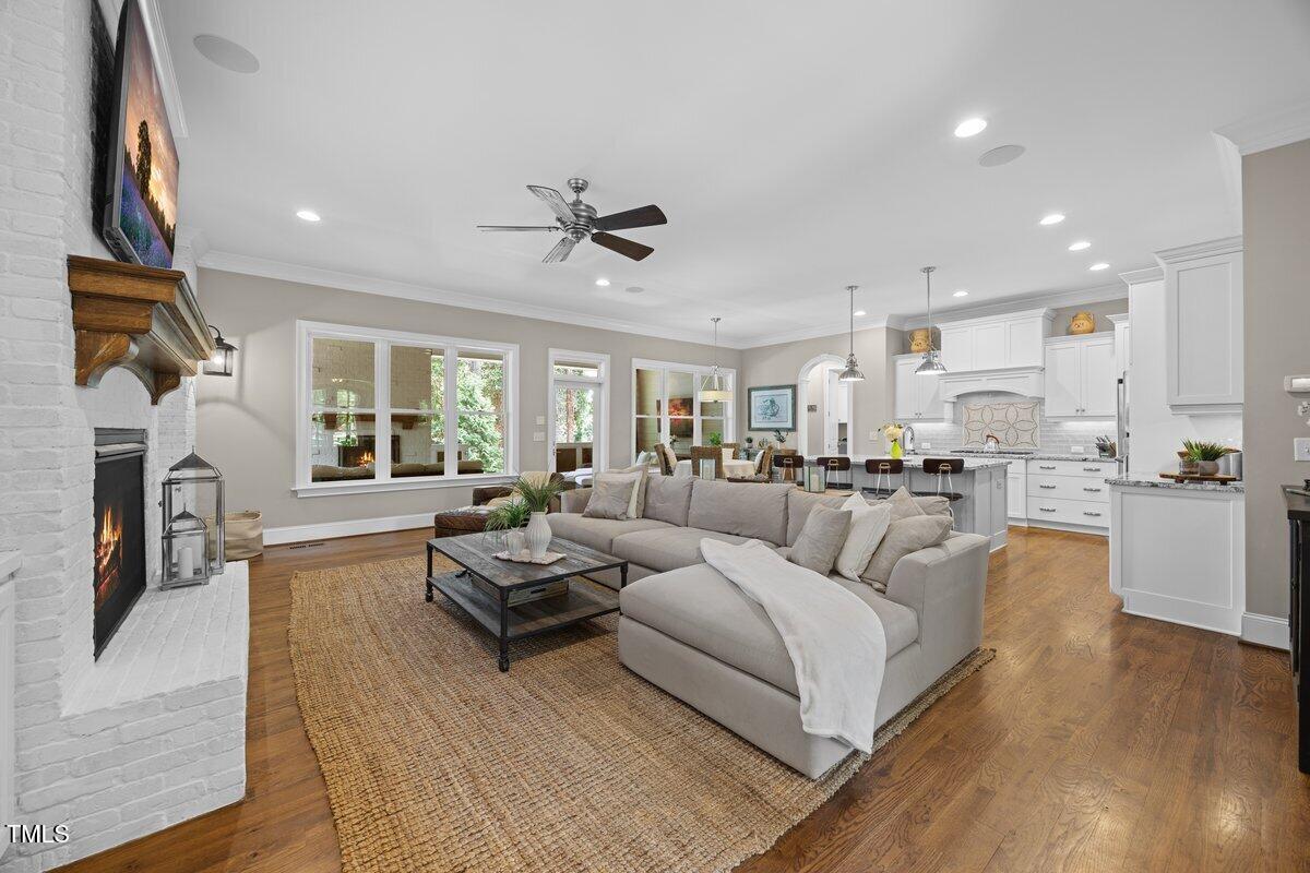 3034 Lewis Farm Road Raleigh, NC 27607 - Photo 22 of 60 a living room with fireplace furniture and a wooden floor