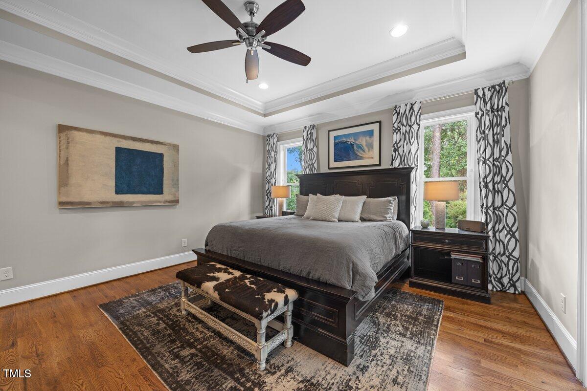 3034 Lewis Farm Road Raleigh, NC 27607 - Photo 26 of 60 a bedroom with a bed and wooden floor