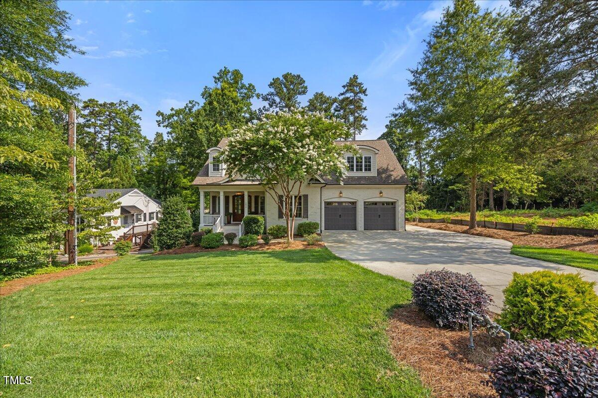3034 Lewis Farm Road Raleigh, NC 27607 - Photo 3 of 60 a front view of a house with garden
