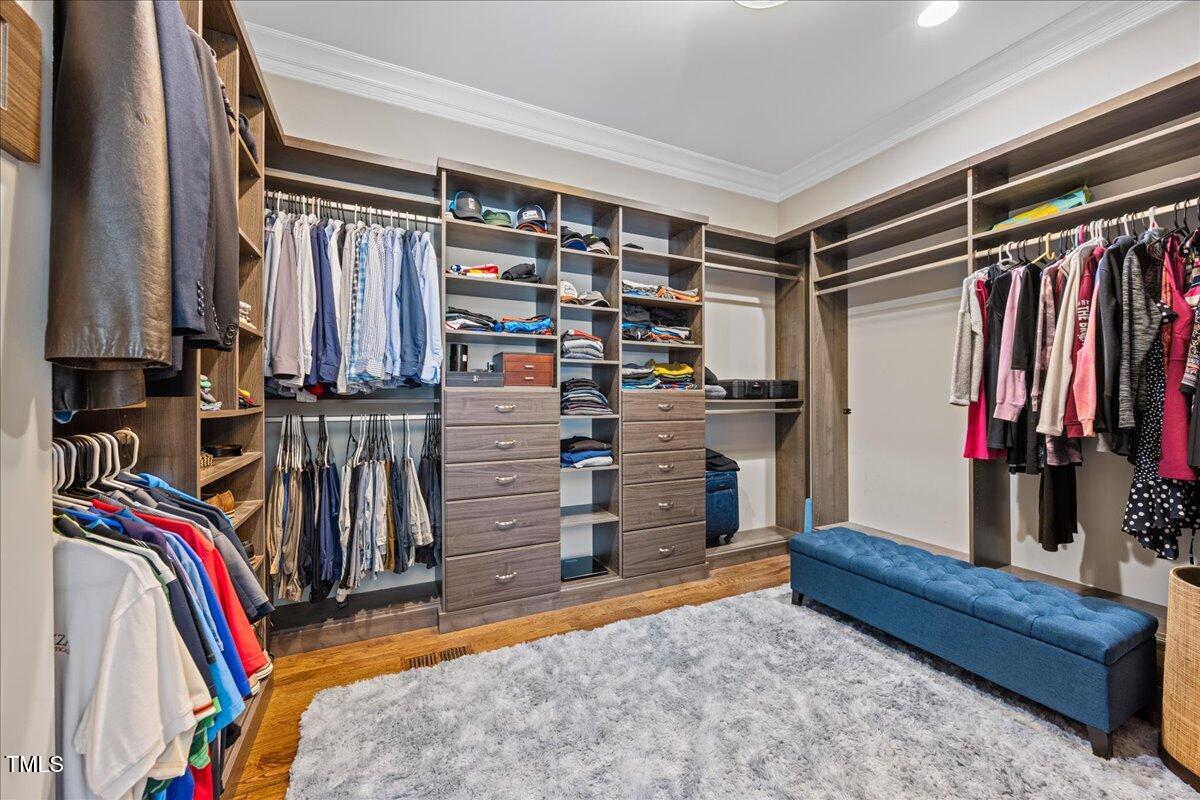 3034 Lewis Farm Road Raleigh, NC 27607 - Photo 31 of 60 a view of walk in closet with clothes and shoes