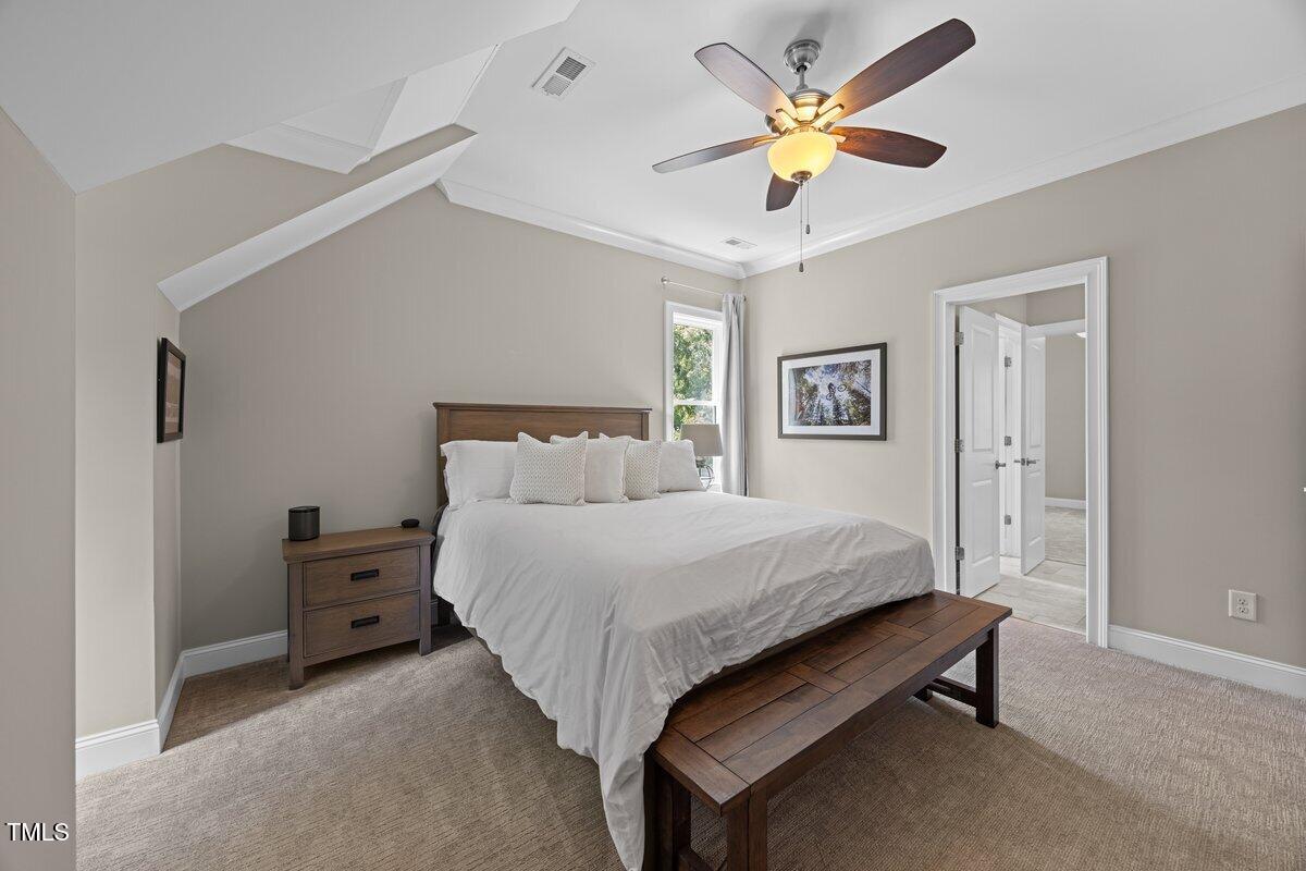 3034 Lewis Farm Road Raleigh, NC 27607 - Photo 42 of 60 a bedroom with a bed and a chandelier