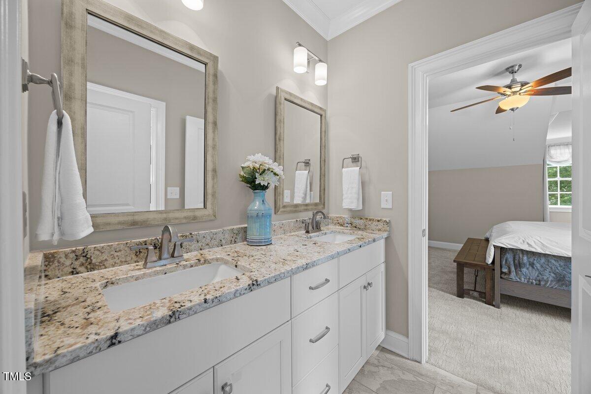 3034 Lewis Farm Road Raleigh, NC 27607 - Photo 43 of 60 a bathroom with a granite countertop sink double vanity and a mirror