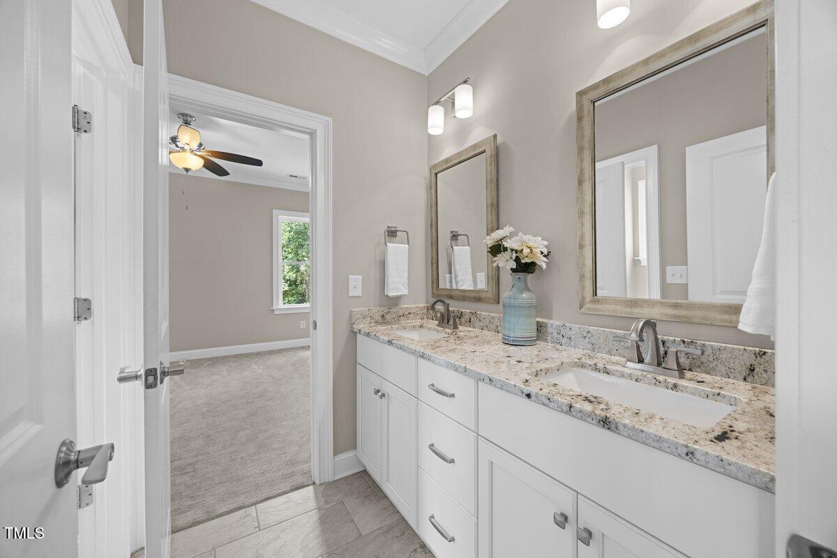 3034 Lewis Farm Road Raleigh, NC 27607 - Photo 44 of 60 a bathroom with a granite countertop sink and a mirror