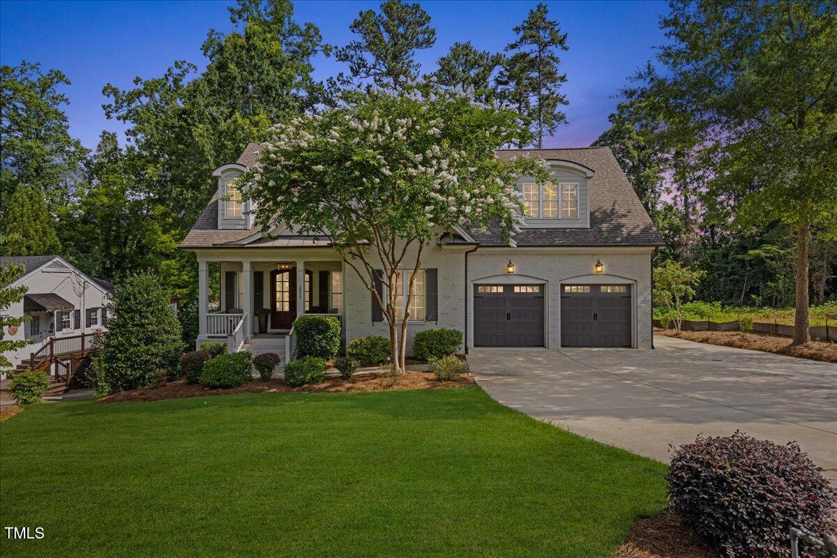 3034 Lewis Farm Road Raleigh, NC 27607 - Photo 6 of 60 a front view of a house with a garden and trees