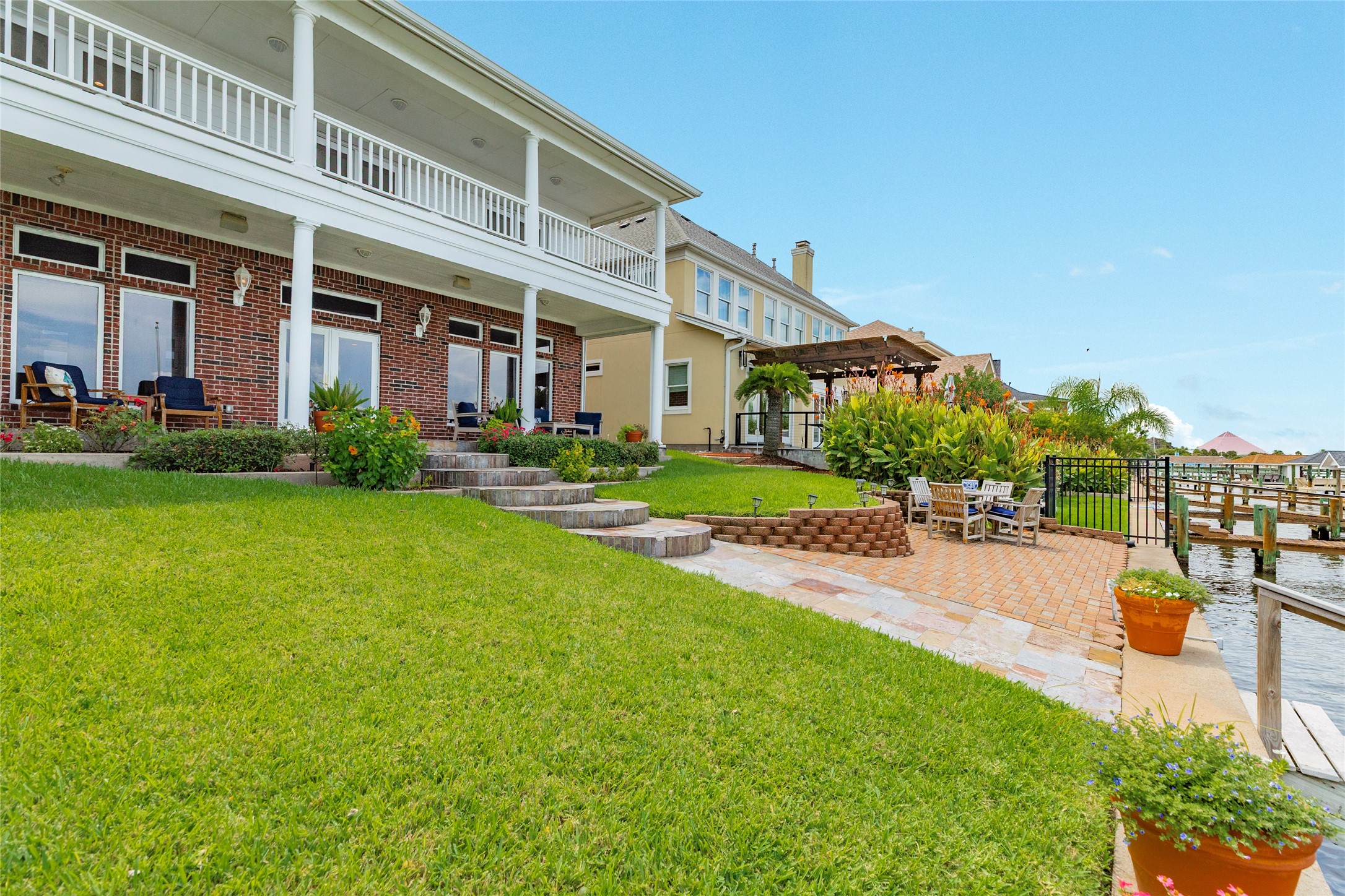 7306 Offats Point Circle Galveston, TX 77551 - Photo 12 of 50 a front view of a building with garden and trees