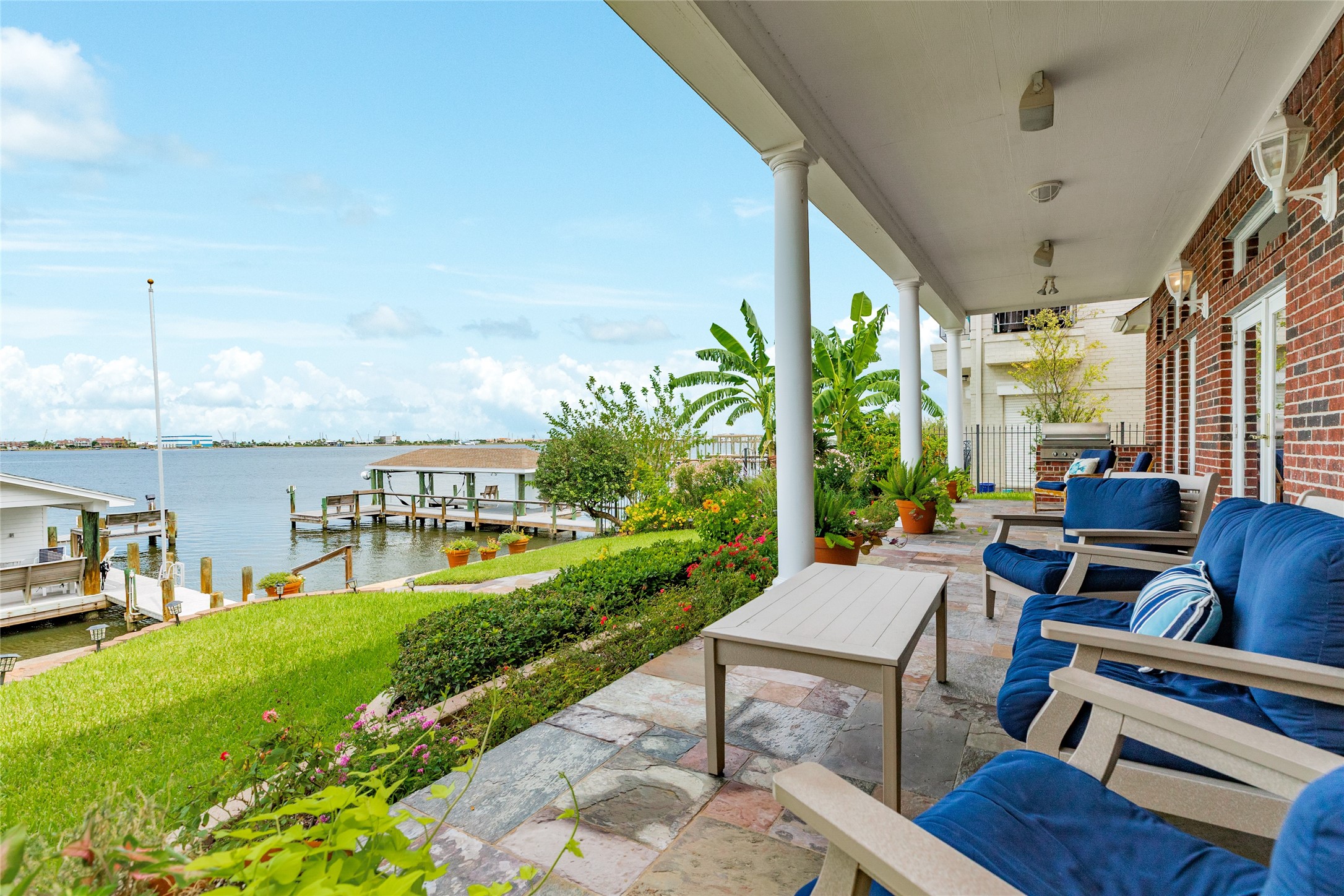 7306 Offats Point Circle Galveston, TX 77551 - Photo 14 of 50 a view of a patio with couches chairs potted plants and a big yard