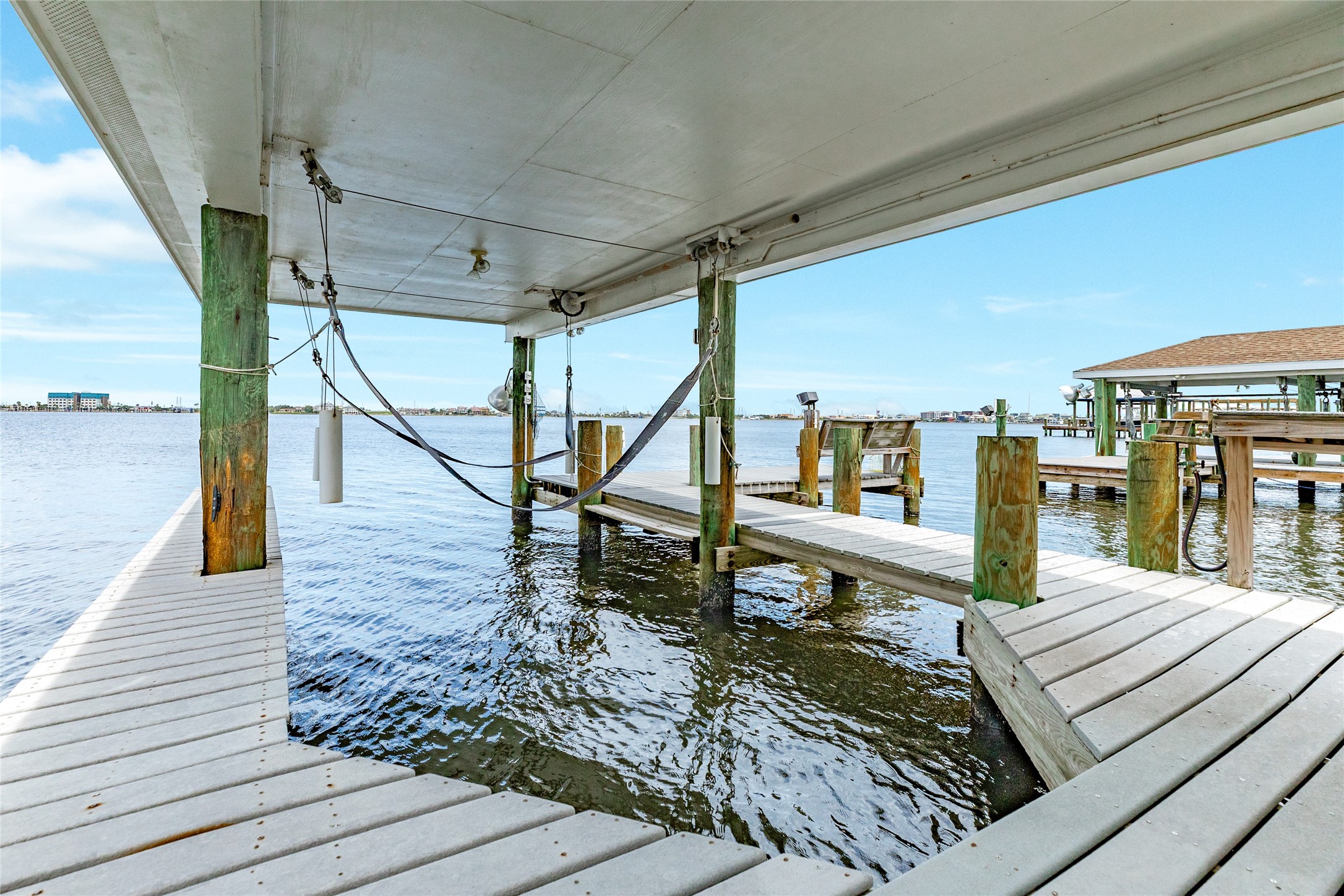 7306 Offats Point Circle Galveston, TX 77551 - Photo 19 of 50 a view of a deck with wooden floor and outdoor seating