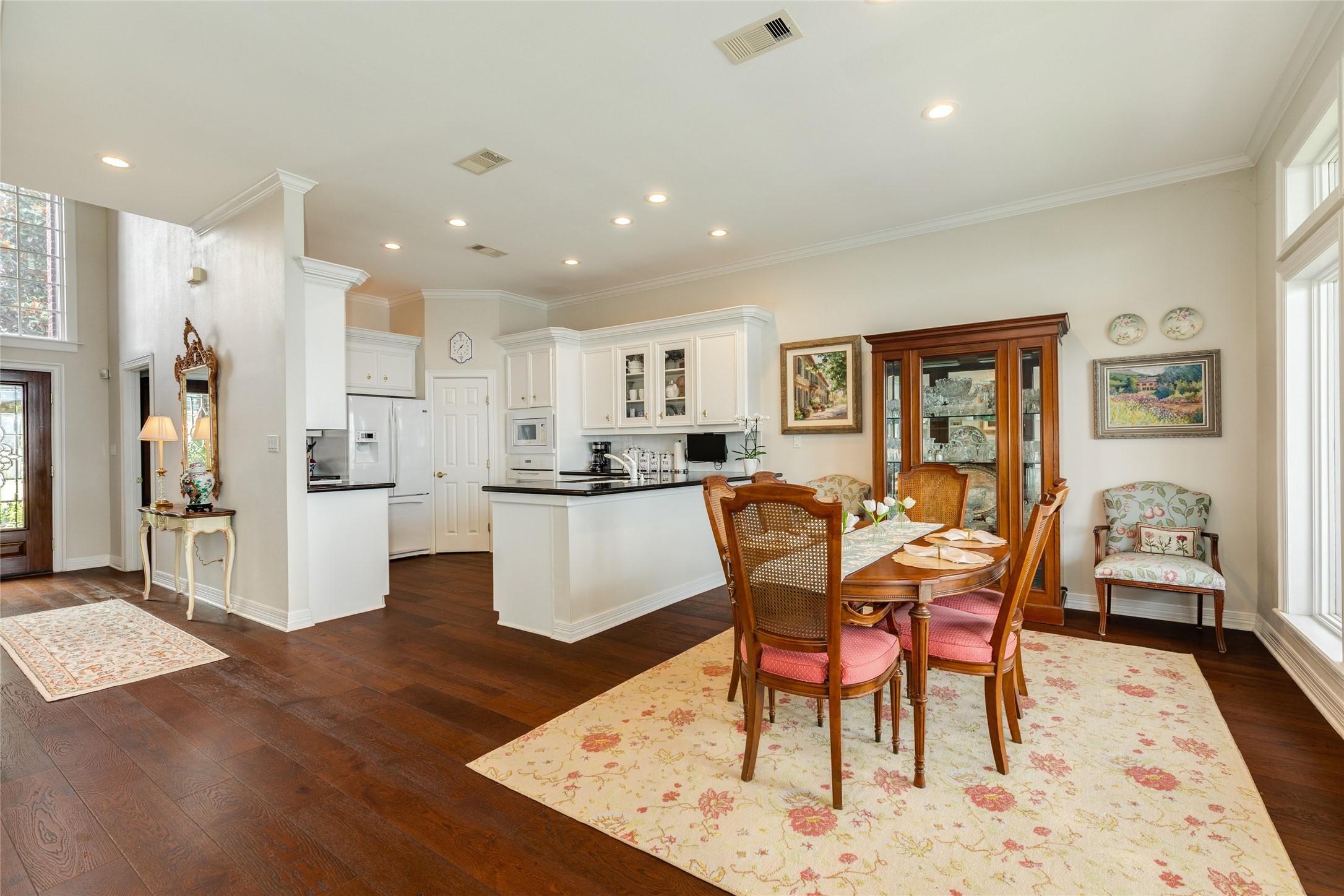 7306 Offats Point Circle Galveston, TX 77551 - Photo 22 of 50 a dining room with stainless steel appliances kitchen island granite countertop a dining table chairs and a refrigerator
