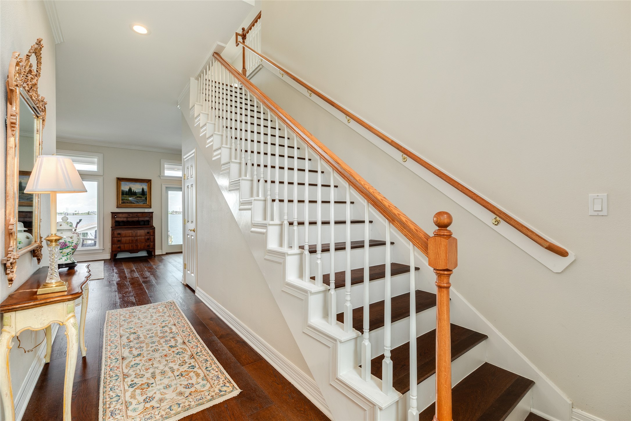 7306 Offats Point Circle Galveston, TX 77551 - Photo 37 of 50 a view of staircase with lots of frames on wall and a rug