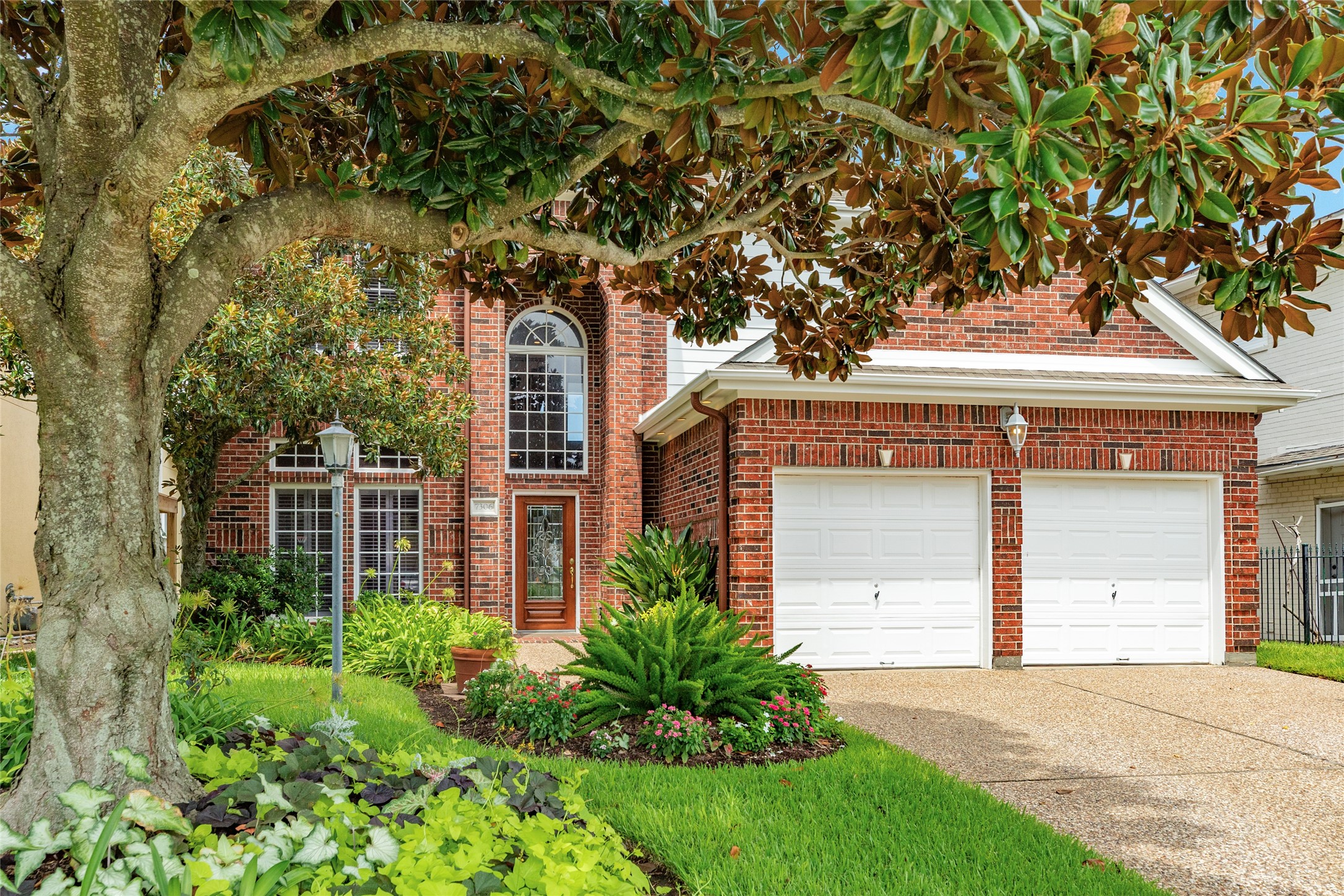 7306 Offats Point Circle Galveston, TX 77551 - Photo 4 of 50 a front view of a house with garden