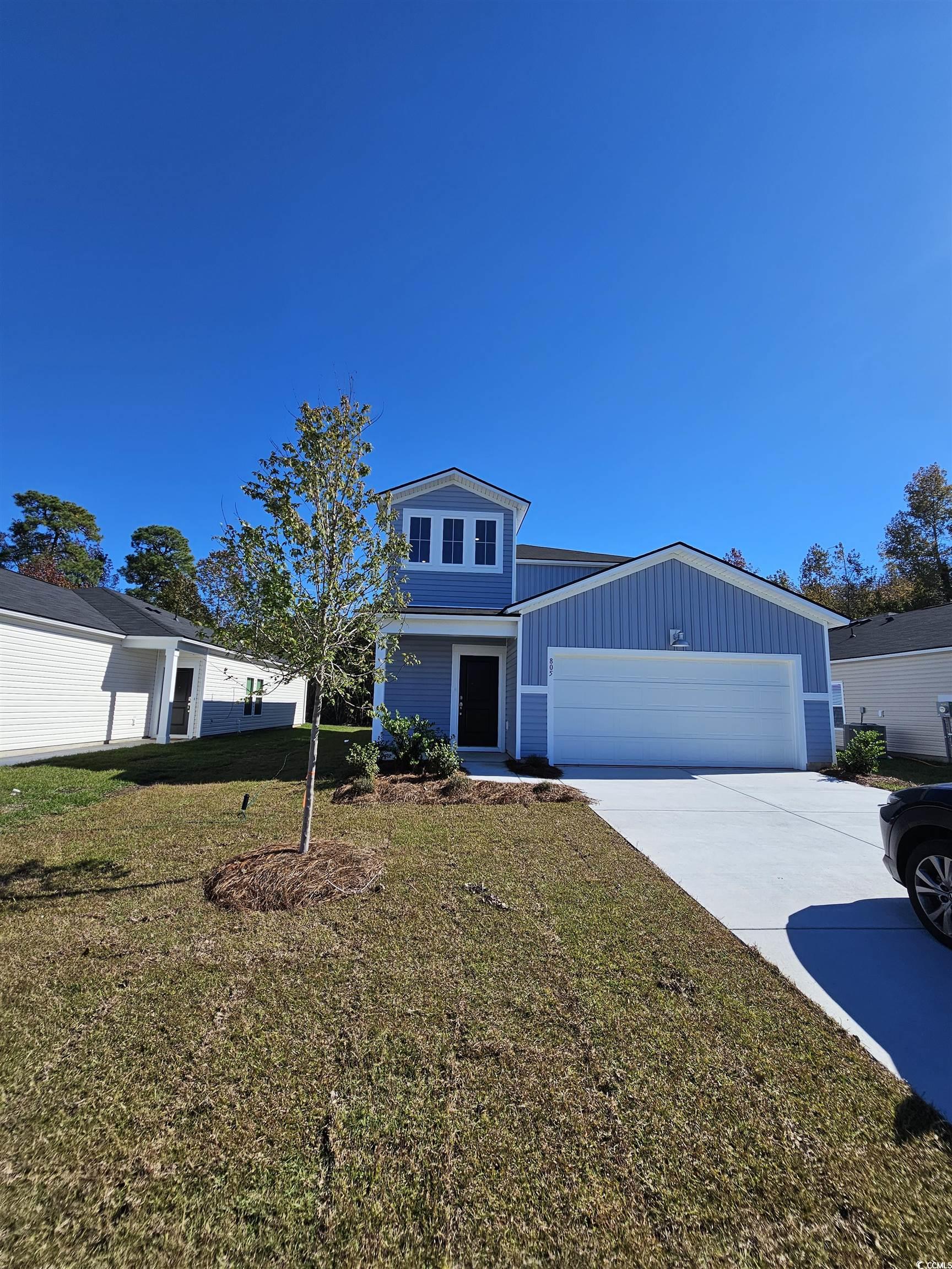 805 Wapama Street Little River, SC 29566 - Photo 22 of 25 Traditional-style house featuring a front lawn, driveway, board and batten siding, and an attached garage