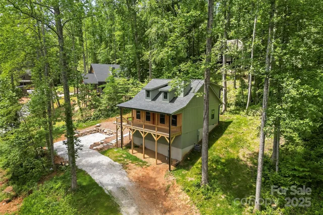 an aerial view of a house with a big yard