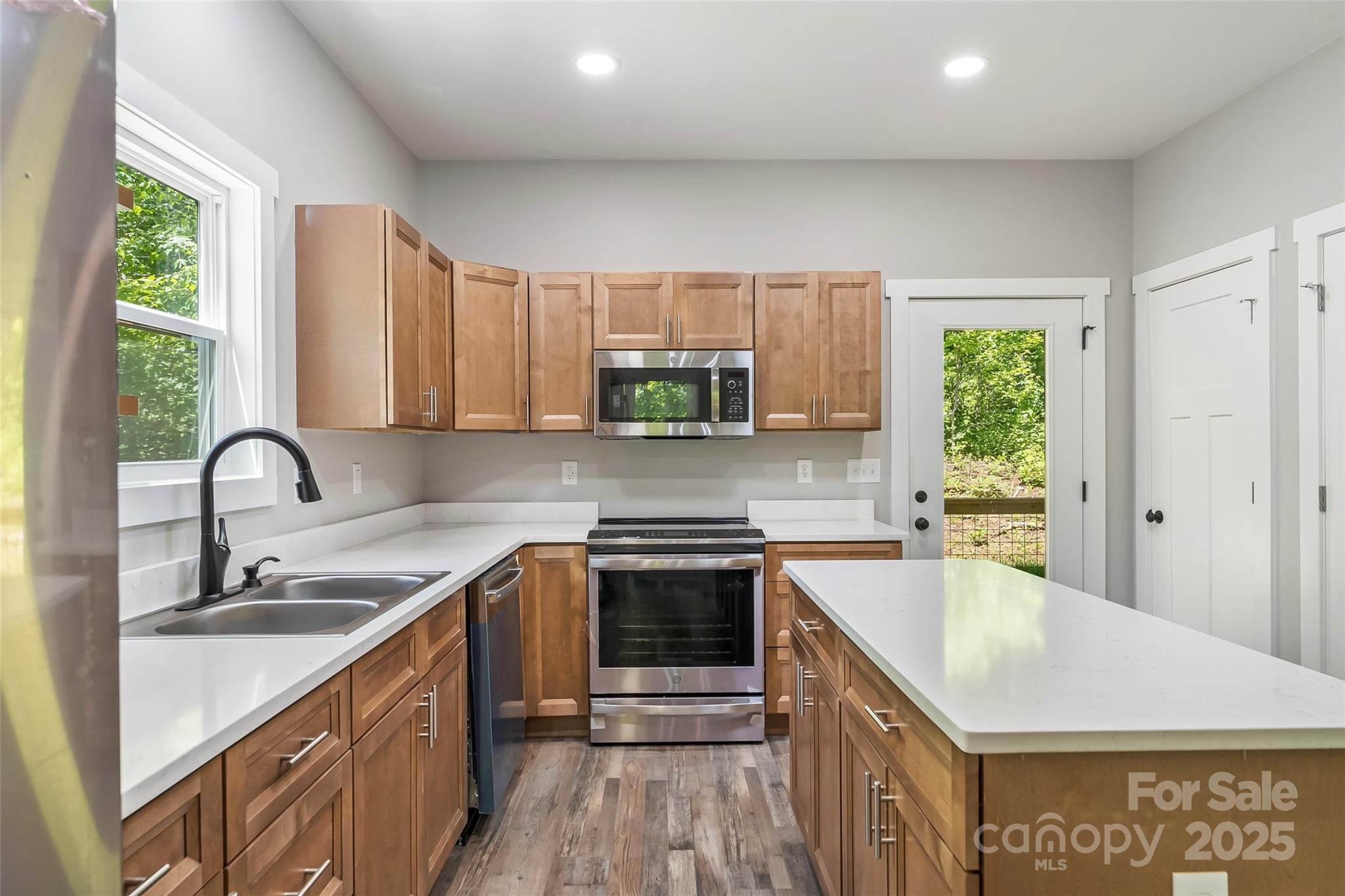 511 Blue Ridge Drive North Marion, NC 28752 - Photo 12 of 41 a kitchen with stainless steel appliances granite countertop a sink stove and refrigerator