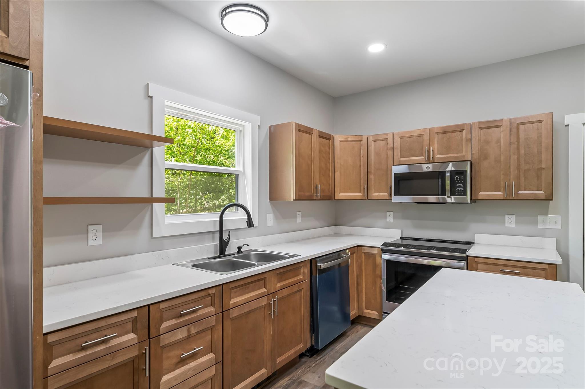 511 Blue Ridge Drive North Marion, NC 28752 - Photo 13 of 41 a kitchen with kitchen island granite countertop a sink stainless steel appliances and cabinets