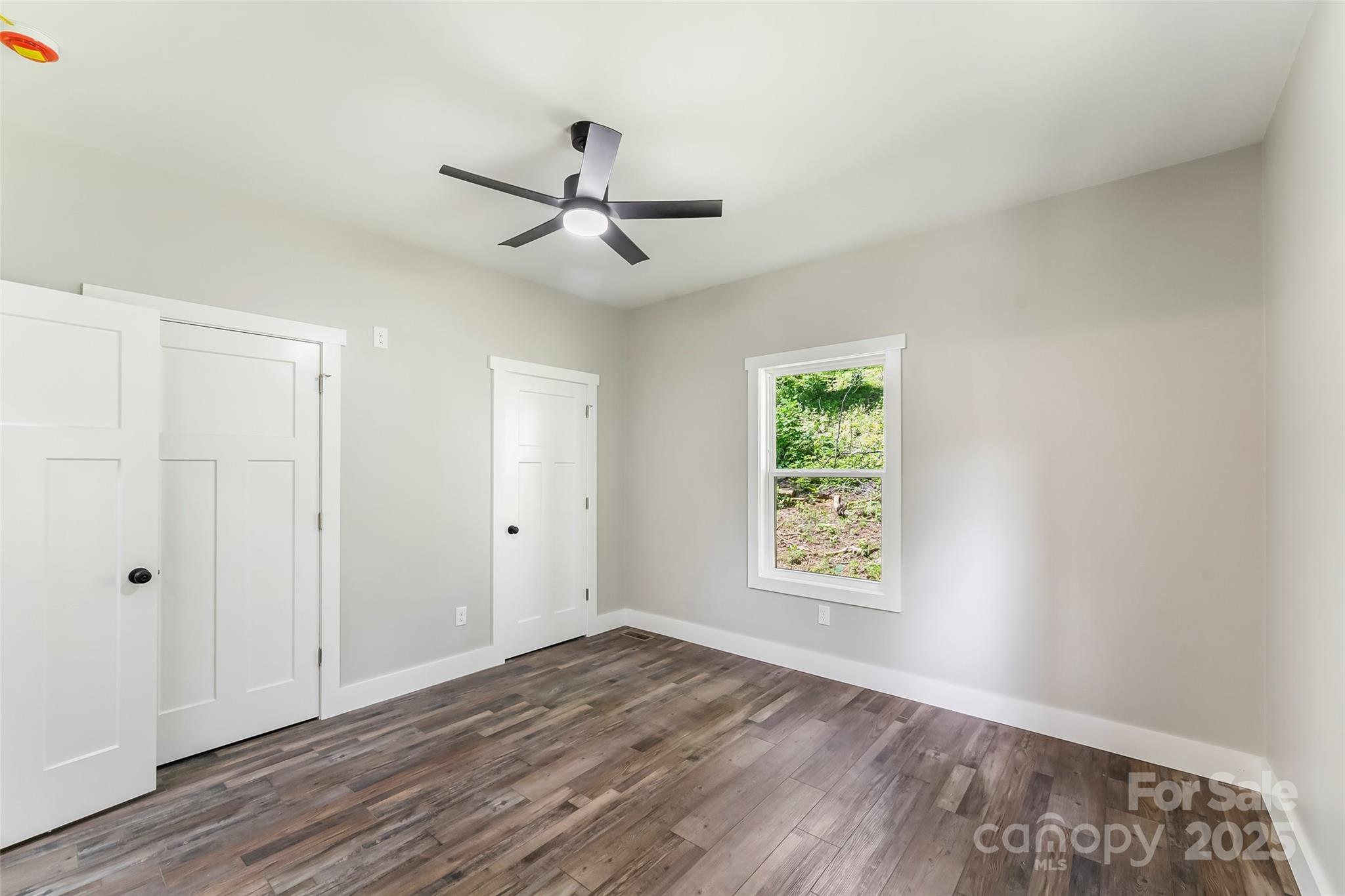 511 Blue Ridge Drive North Marion, NC 28752 - Photo 16 of 41 a view of an empty room with a window and wooden floor
