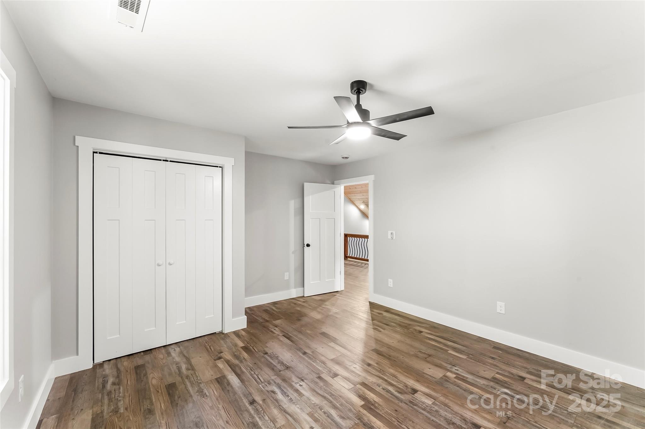 511 Blue Ridge Drive North Marion, NC 28752 - Photo 25 of 41 a view of a big room with wooden floor and a ceiling fan