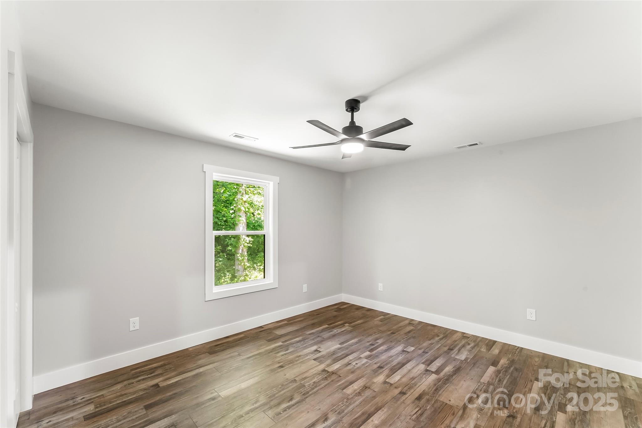 511 Blue Ridge Drive North Marion, NC 28752 - Photo 26 of 41 a view of empty room with wooden floor and fan