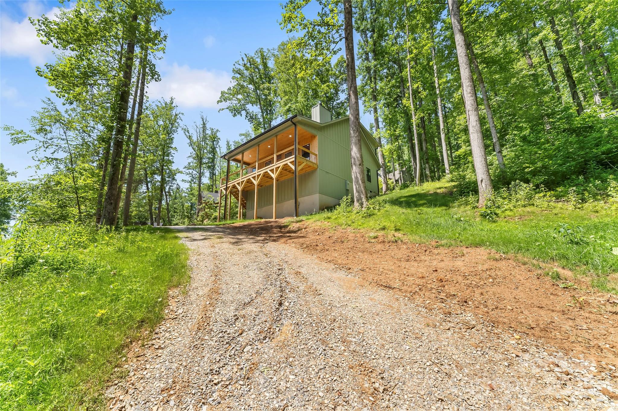 511 Blue Ridge Drive North Marion, NC 28752 - Photo 35 of 41 a backyard of a house with large trees and plants