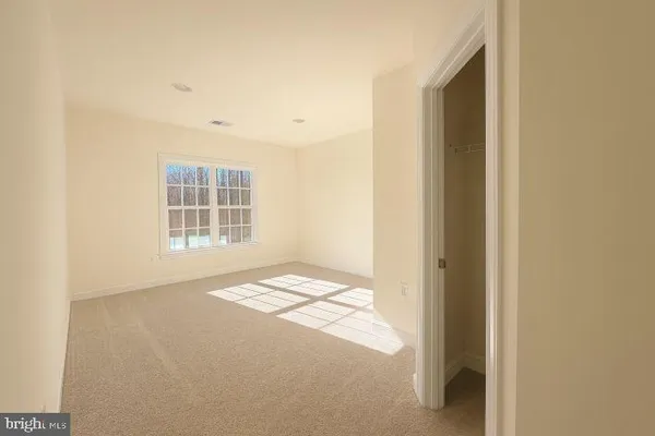 a view of an empty room and a window