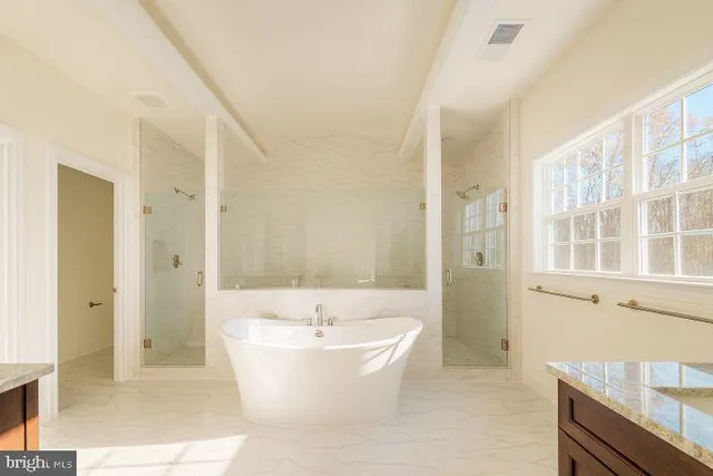 a white bath tub sitting in a en suite bathroom